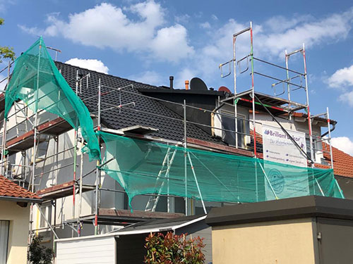 Dachbeschichtung rot, bei der Arbeit